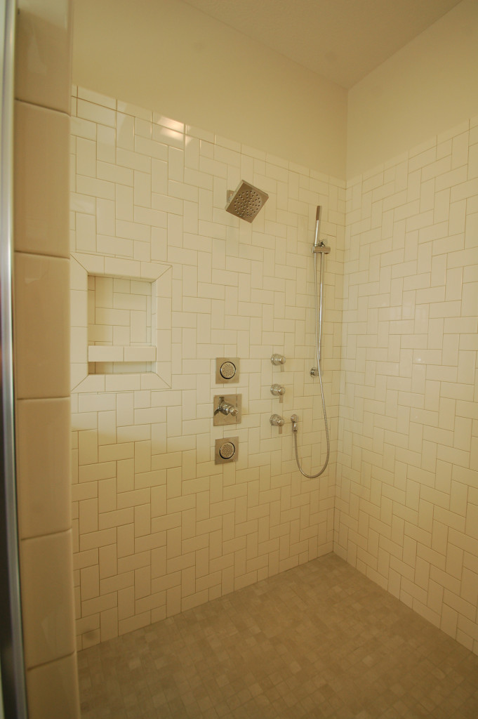 90 Degree Thermostatic and Volume Controls, 90 degree Immersion shower head, Square Recessed Body Sprays, Fina handshower and slide bar. All made by Moen.